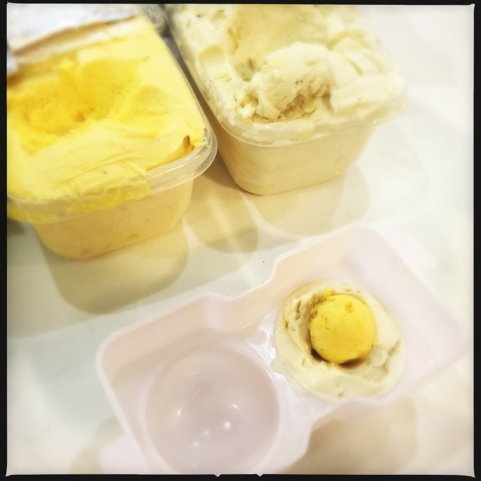 Vanilla ice cream encasing passionfruit sorbet spheres in a plastic mold.
